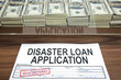 Approved disaster loan application form and dollar bills