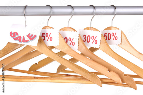 Photo: wooden clothes hangers as sale symbol isolated on white wooden clothes hangers as sale symbol isolated on white