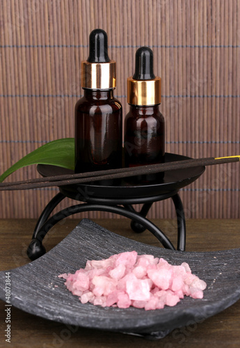 Photo: aromatherapy setting on brown bamboo background . aromatherapy setting on brown bamboo background .