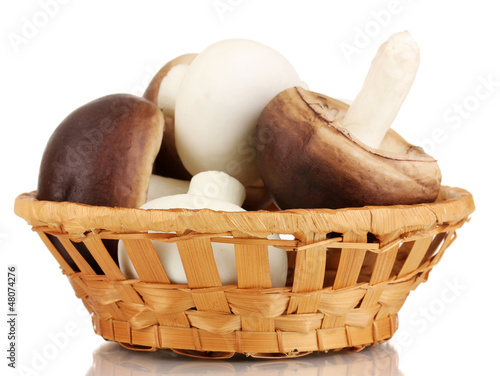 Photo: Fresh mushrooms in basket isolated on white Fresh mushrooms in basket isolated on white