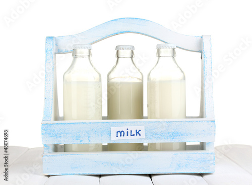 Photo: Milk in bottles in wooden box Milk in bottles in wooden box