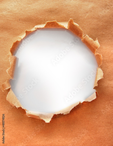 Photo: Torn kraft paper background Torn kraft paper background