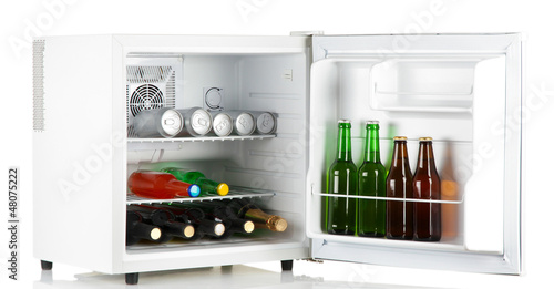 Photo: Mini fridge full of bottles of alcoholic beverages isolated Mini fridge full of bottles of alcoholic beverages isolated