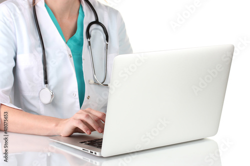 Photo: Doctor using laptop computer isolated on white Doctor using laptop computer isolated on white