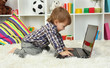 cute little boy and notebook in room