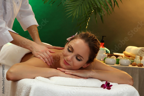 Photo: beautiful woman in spa salon with stones getting massage, beautiful woman in spa salon with stones getting massage,