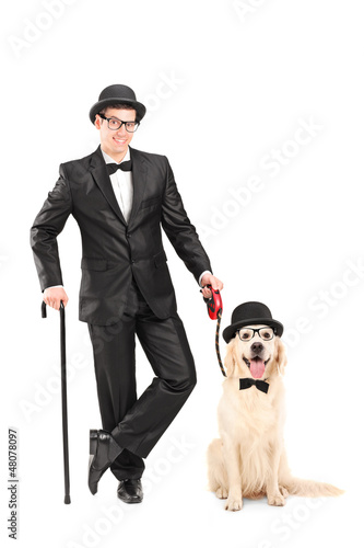 Photo: Magician with bow tie holding cane and dog Magician with bow tie holding cane and dog