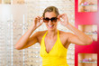 Young woman at optician with sunglasses