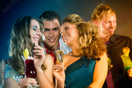 Photo: People in club or bar drinking cocktails People in club or bar drinking cocktails