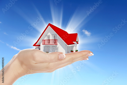 Illustration: the house in hands on blue sky the house in hands on blue sky