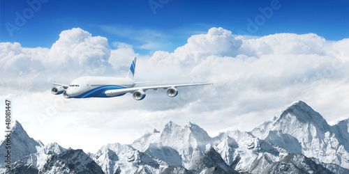 Photo: White passenger plane above the mountains White passenger plane above the mountains