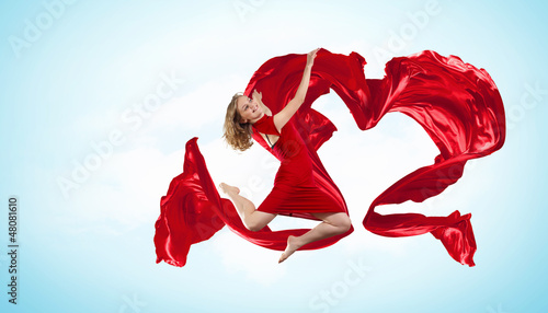 Photo: Dancing young woman with flying fabric Dancing young woman with flying fabric