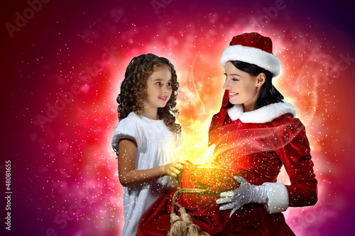 Photo: Little girl with christmas gifts and santa Little girl with christmas gifts and santa