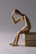 Wooden Modelling Mannequin Sitting and Thinking