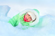 Cheerful girl lying in deep snow drift
