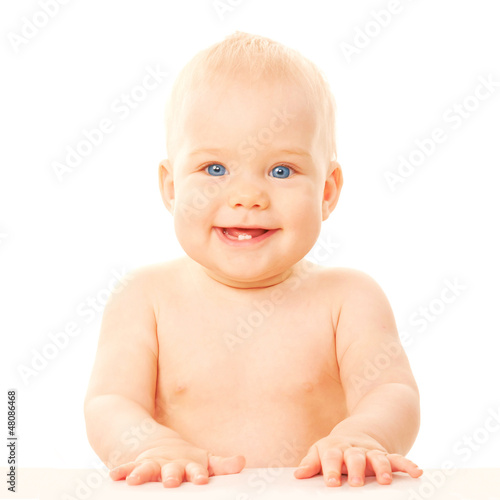Photo: Smiling baby with two teeth. Smiling baby with two teeth.