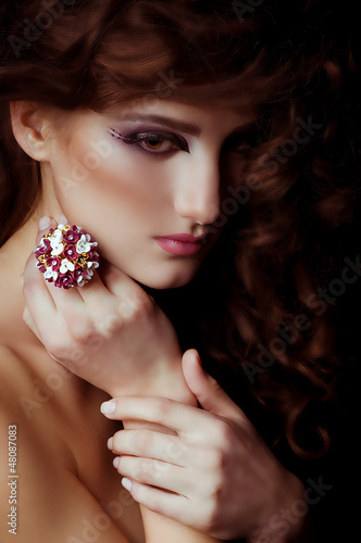 Photo: young woman with makeup in luxury jewelry young woman with makeup in luxury jewelry