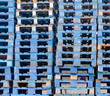 Photo: Piled blue wooden euro pallets background pattern Piled blue wooden euro pallets background pattern