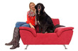 Young woman with her dog on a couch