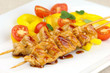 Glazed turkey breast skewers with bell pepper and tomato salad