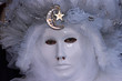 Person in Venetian costume attends Carnival of Venice.