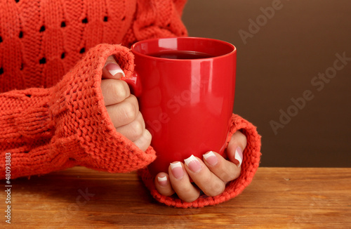 Photo: hands holding mug of hot drink, close-up hands holding mug of hot drink, close-up