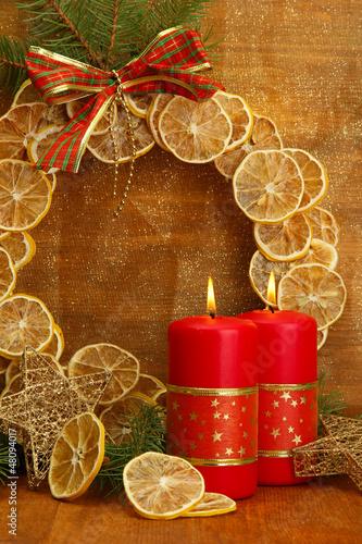 Photo: Two candles and christmas decorations, on golden background Two candles and christmas decorations, on golden background