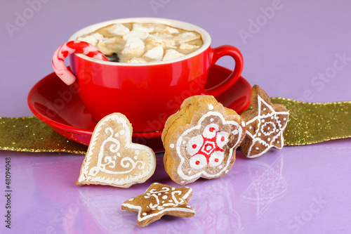 Photo: Cup of coffee with Christmas sweetness on purple background Cup of coffee with Christmas sweetness on purple background