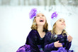 Two Little Girls Sitting in Snowfall