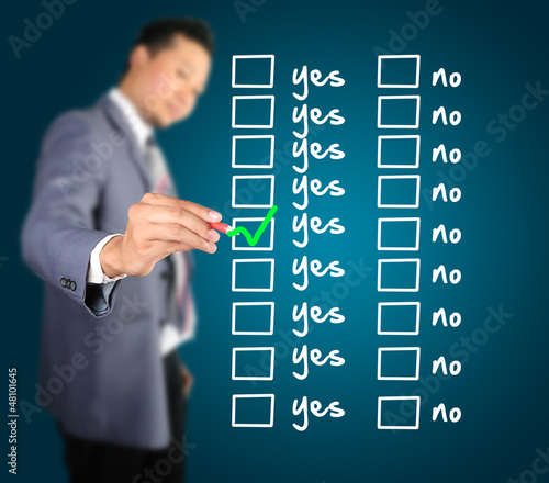 Photo: Business man designed yes or no checklist Business man designed yes or no checklist