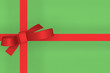 Red gift ribbon bow on green background
