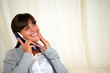 Smiling pretty woman conversing on phone