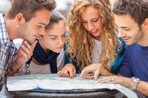 Photo: Group of Tourists Looking at Map Group of Tourists Looking at Map