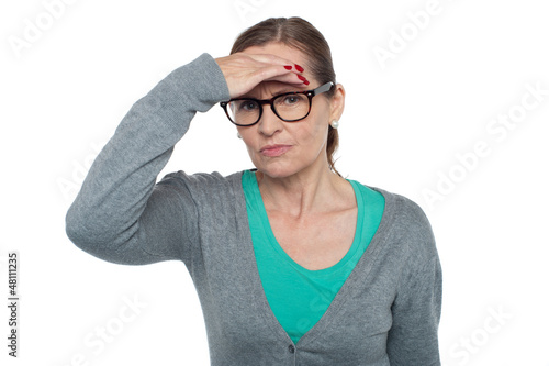 Photo: Expressionless woman looking at distance object Expressionless woman looking at distance object