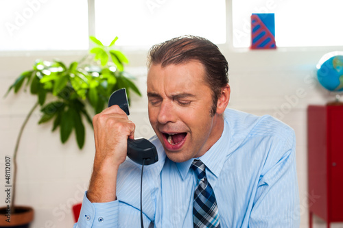 Photo: Businessman yelling during the phone call Businessman yelling during the phone call