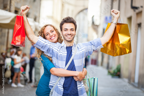 Photo: Happy Young Couple with Shopping Bags Happy Young Couple with Shopping Bags