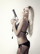 Beautiful blond woman with gun
