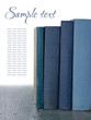 Blue old books on wooden background