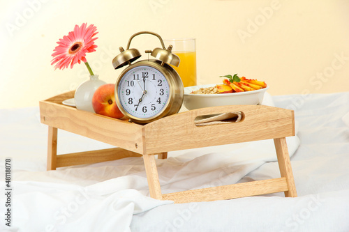 Photo: wooden tray with light breakfast on bed wooden tray with light breakfast on bed