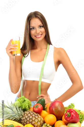 Photo: beautiful young woman with fruits and vegetables and glass of beautiful young woman with fruits and vegetables and glass of