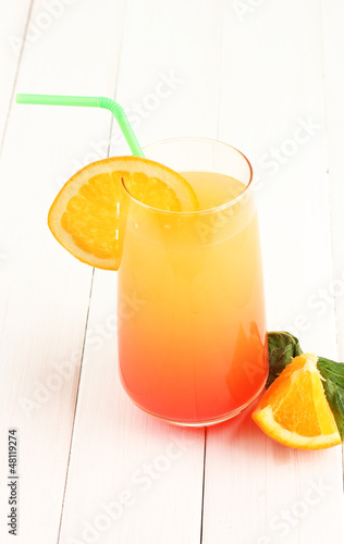 Photo: Glass of multicolor cocktail on white background Glass of multicolor cocktail on white background