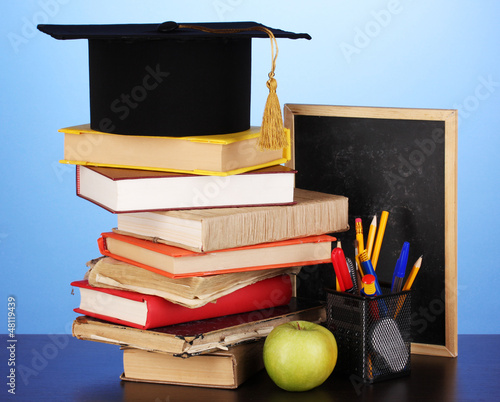 Photo: Books and magister cap against school board Books and magister cap against school board