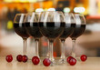 Red wine in glass on room background