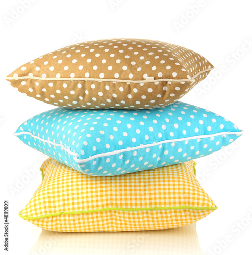 Photo: Blue, brown and yellow bright pillows isolated on white Blue, brown and yellow bright pillows isolated on white