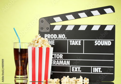 Photo: Movie clapperboard, cola and popcorn on background Movie clapperboard, cola and popcorn on background