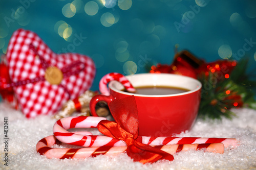Photo: Hot tasty drink in red cup with Christmas candies Hot tasty drink in red cup with Christmas candies