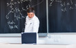 Senior chemistry professor writing on the board