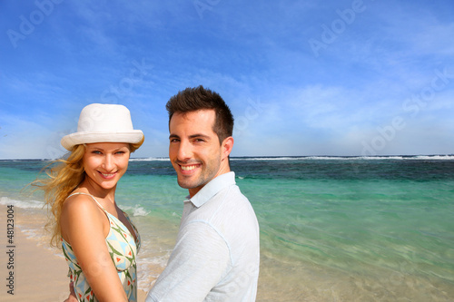 Photo: Portrait of cheerful couple at the beach Portrait of cheerful couple at the beach