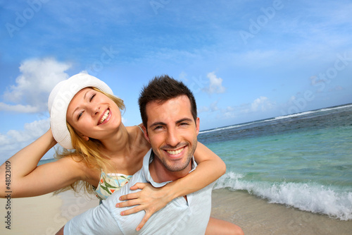 Photo: Cheerful couple enjoying vacation at the beach Cheerful couple enjoying vacation at the beach