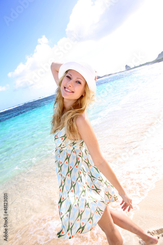Photo: Smiling attractive girl at the beach Smiling attractive girl at the beach